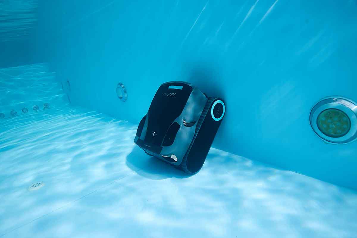 Above ground robotic pool cleaner near the pool wall