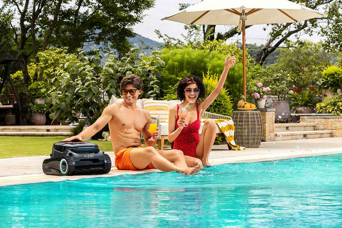 Automatic pool vacuum moving along the bottom of a swimming pool
