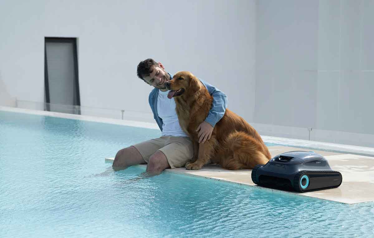 Cordless automatic pool cleaner near the edge of a swimming pool