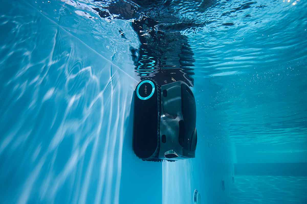 Residential pool cleaning robot working through an inground swimming pool